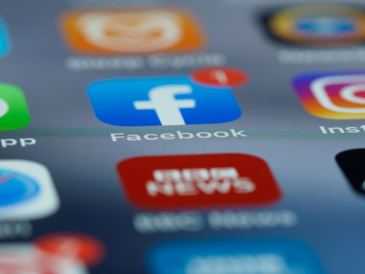 Home Close-up of smartphone screen displaying various social media app icons including Facebook.