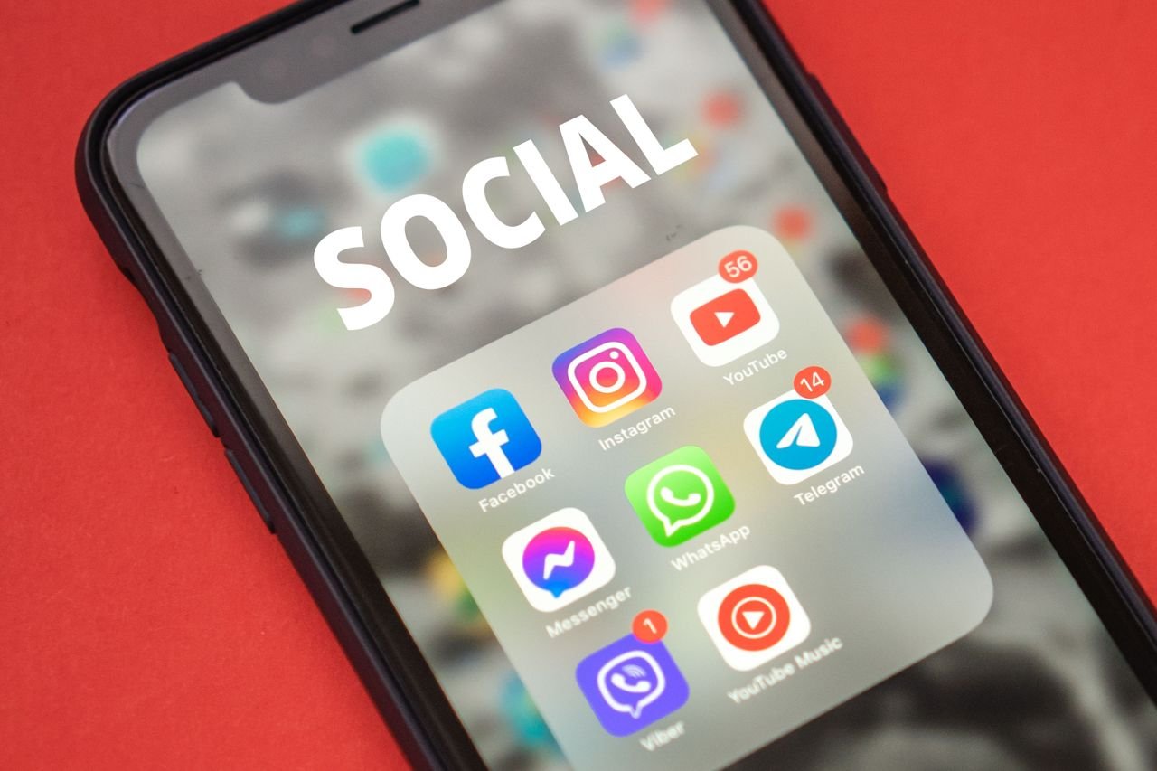 Home Close-up of a smartphone showing popular social media apps on screen.